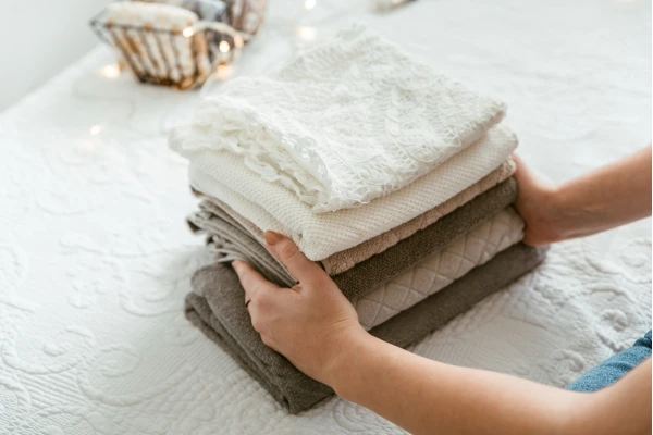 Hands folding towels